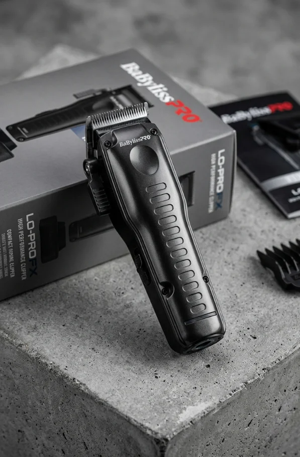 BaBylissPRO FXONE LO-PROFX high performance clipper displayed on a concrete surface with product box in the background.
